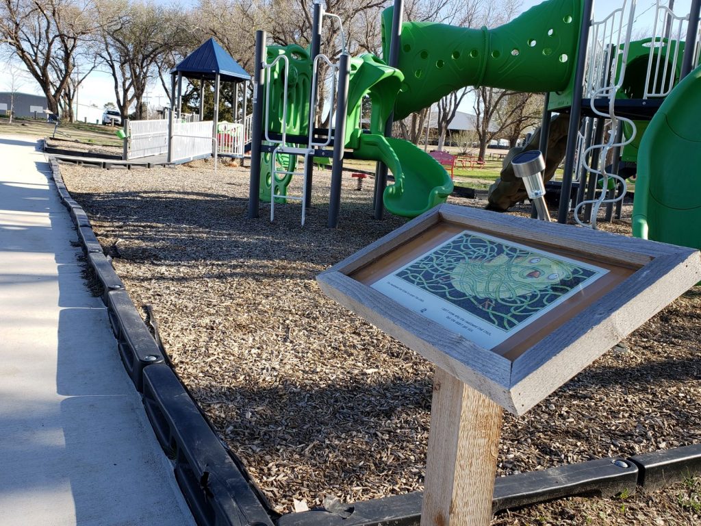 Storywalk post at playground in county park.